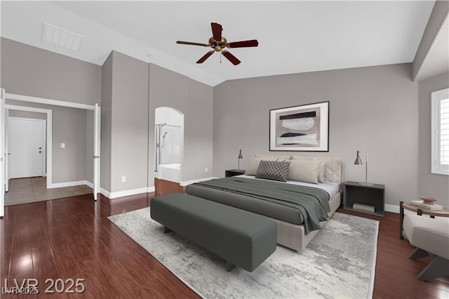 4029 Ricebird Way N, Las Vegas, NV 89084 - bedroom featuring dark wood-style flooring, arched walkways, vaulted ceiling, and a ceiling fan