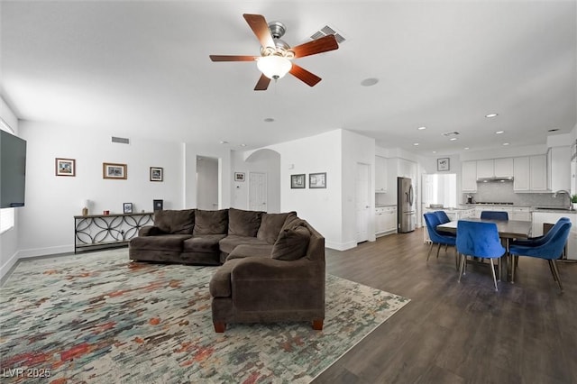 2229 Armacost Dr, Henderson, NV 89074 - living area featuring a ceiling fan, arched walkways, dark wood-type flooring, and recessed lighting