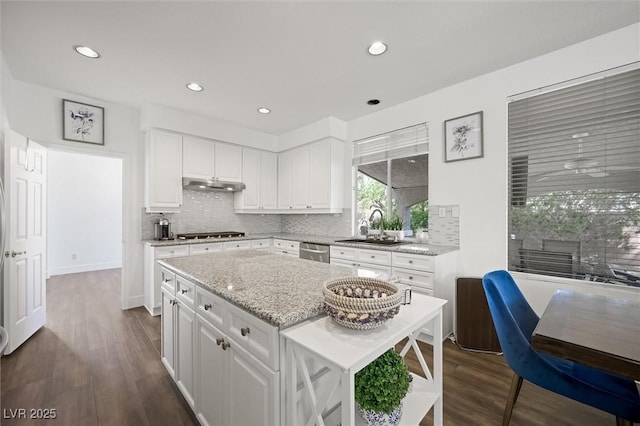2229 Armacost Dr, Henderson, NV 89074 - kitchen with under cabinet range hood, dishwasher, gas cooktop, backsplash, and recessed lighting