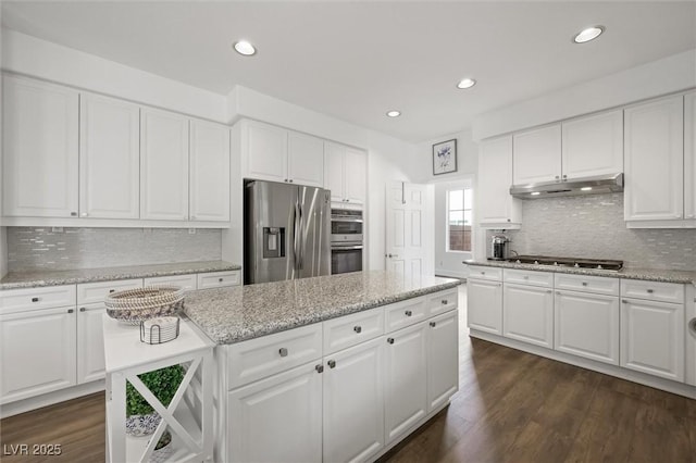 2229 Armacost Dr, Henderson, NV 89074 - kitchen featuring stainless steel appliances, under cabinet range hood, a kitchen island, recessed lighting, and tasteful backsplash