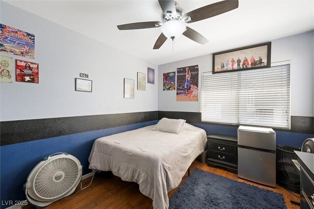 2229 Armacost Dr, Henderson, NV 89074 - bedroom with freestanding refrigerator, wood finished floors, and a ceiling fan