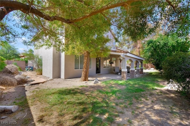 2229 Armacost Dr, Henderson, NV 89074 - back of house with stucco siding and a patio area