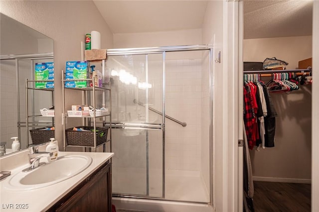 7231 Sequoia Springs Dr, Las Vegas, NV 89147 - full bathroom with a spacious closet, vanity, a shower stall, and wood finished floors