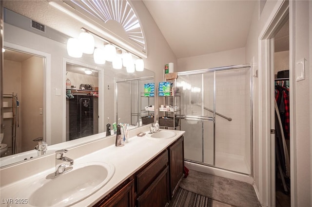 7231 Sequoia Springs Dr, Las Vegas, NV 89147 - full bath featuring a walk in closet, a shower stall, double vanity, and vaulted ceiling