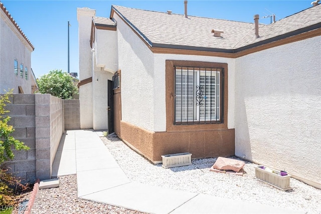 7231 Sequoia Springs Dr, Las Vegas, NV 89147 - view of home's exterior featuring stucco siding and roof with shingles