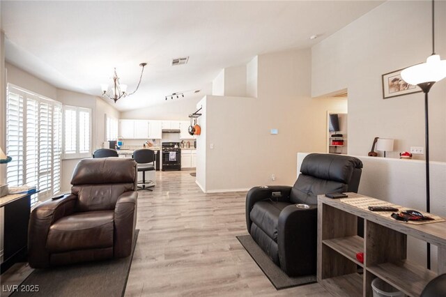 7231 Sequoia Springs Dr, Las Vegas, NV 89147 - living area with a chandelier, light wood-type flooring, and high vaulted ceiling