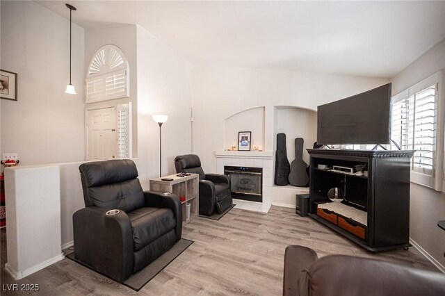 7231 Sequoia Springs Dr, Las Vegas, NV 89147 - living room with lofted ceiling, wood finished floors, and a tiled fireplace