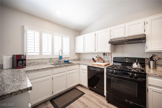 7231 Sequoia Springs Dr, Las Vegas, NV 89147 - kitchen featuring black appliances, under cabinet range hood, light wood-style floors, vaulted ceiling, and white cabinetry