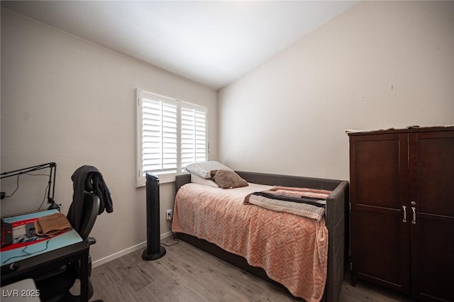 7231 Sequoia Springs Dr, Las Vegas, NV 89147 - bedroom with light wood-style flooring and vaulted ceiling