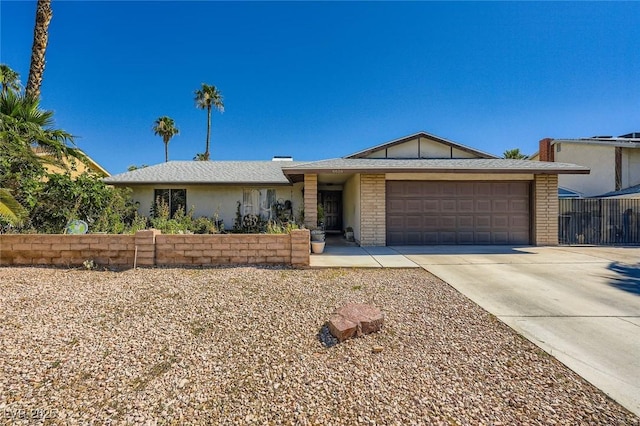 6616 Celeste Ave, Las Vegas, NV 89107 - ranch-style house with a garage, driveway, and brick siding