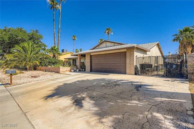 6616 Celeste Ave, Las Vegas, NV 89107 - view of front of home featuring an attached garage, concrete driveway, and brick siding