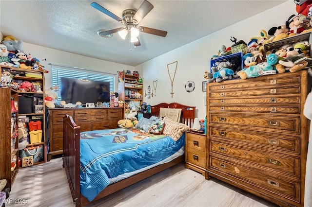 6616 Celeste Ave, Las Vegas, NV 89107 - bedroom with light wood-style floors, a textured ceiling, and ceiling fan