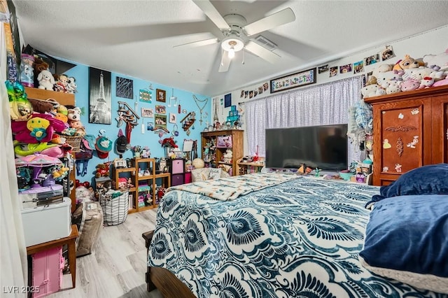6616 Celeste Ave, Las Vegas, NV 89107 - bedroom featuring wood finished floors, a ceiling fan, and a textured ceiling