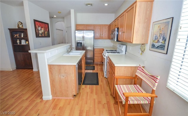 6098 Darkfeather Way, Las Vegas, NV 89139 - kitchen with appliances with stainless steel finishes, light wood-style floors, light countertops, a center island with sink, and recessed lighting