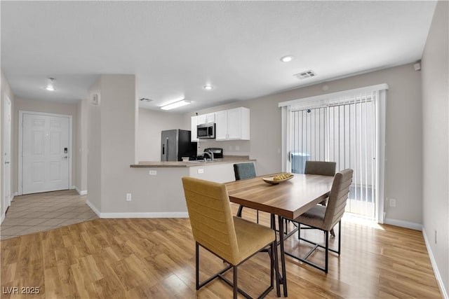 9957 Fine Fern St, Las Vegas, NV 89183 - dining area featuring light wood-type flooring and recessed lighting