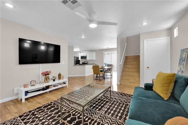 9957 Fine Fern St, Las Vegas, NV 89183 - living area featuring stairway, light wood-type flooring, ceiling fan, plenty of natural light, and recessed lighting