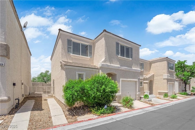 9957 Fine Fern St, Las Vegas, NV 89183 - view of front facade with an attached garage and stucco siding
