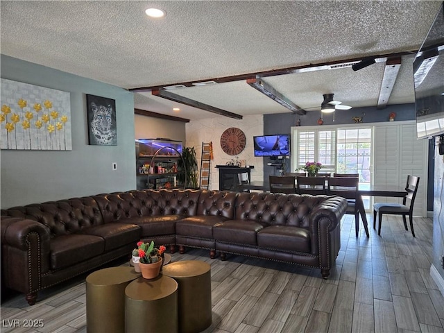 4823 El Tesoro Ave, Las Vegas, NV 89121 - living area featuring a textured ceiling, a ceiling fan, light wood-style flooring, recessed lighting, and beamed ceiling