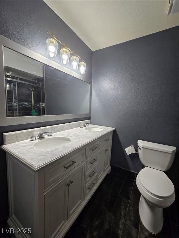 4823 El Tesoro Ave, Las Vegas, NV 89121 - full bath featuring a textured wall, double vanity, and a shower stall