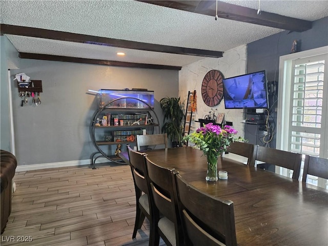 4823 El Tesoro Ave, Las Vegas, NV 89121 - dining area with beam ceiling, a textured ceiling, and wood finished floors