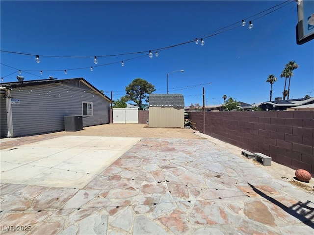 4823 El Tesoro Ave, Las Vegas, NV 89121 - fenced backyard with a storage shed and a patio