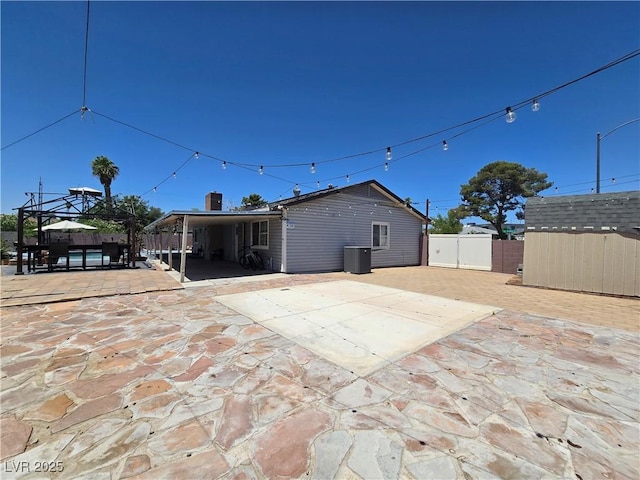 4823 El Tesoro Ave, Las Vegas, NV 89121 - rear view of house featuring a patio, a gazebo, and a storage unit