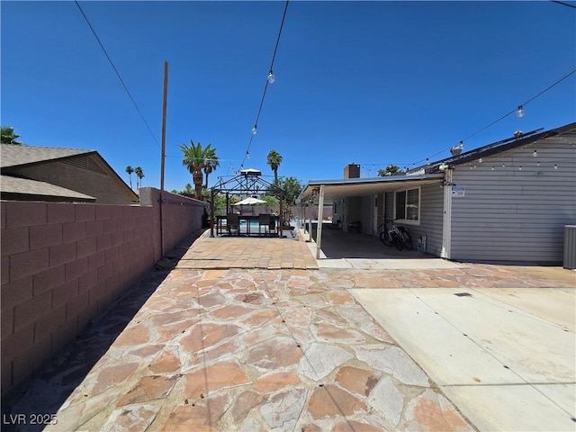 4823 El Tesoro Ave, Las Vegas, NV 89121 - back of property featuring a gazebo, a patio area, and a carport