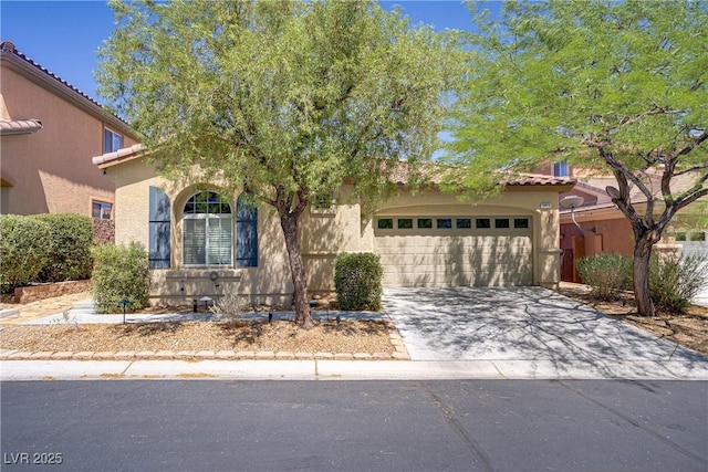 9864 Maspalomas St, Las Vegas, NV 89178 - mediterranean / spanish-style home featuring concrete driveway, stucco siding, a garage, and a tile roof