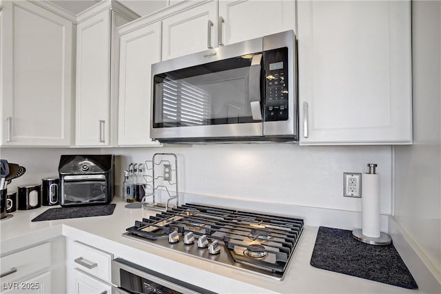 9864 Maspalomas St, Las Vegas, NV 89178 - kitchen with stainless steel appliances, white cabinets, and light countertops