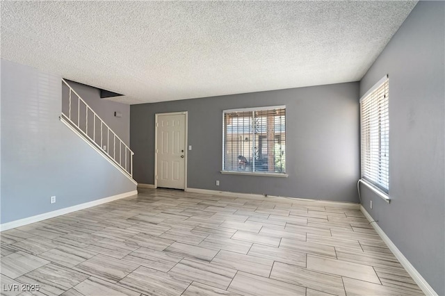 1372 Lorilyn Ave Unit 3, Las Vegas, NV 89119 - foyer with plenty of natural light, a textured ceiling, and stairway