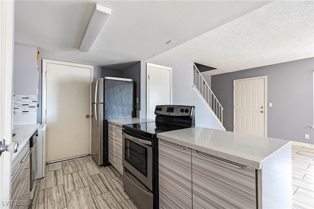 1372 Lorilyn Ave Unit 3, Las Vegas, NV 89119 - kitchen with appliances with stainless steel finishes, light stone countertops, and modern cabinets