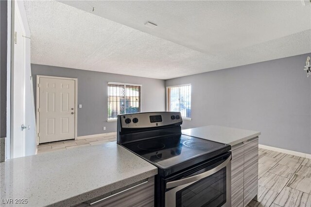 1372 Lorilyn Ave Unit 3, Las Vegas, NV 89119 - kitchen with stainless steel range with electric cooktop, a textured ceiling, and light countertops