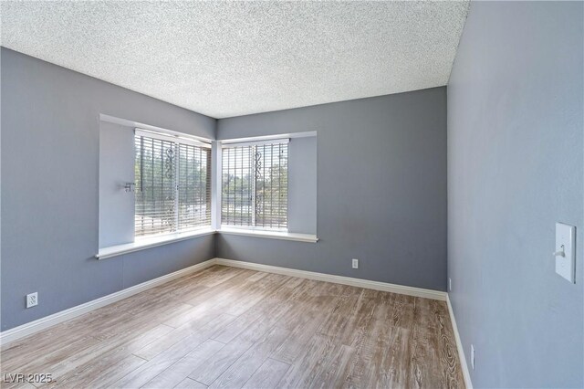1372 Lorilyn Ave Unit 3, Las Vegas, NV 89119 - empty room featuring wood finished floors and a textured ceiling