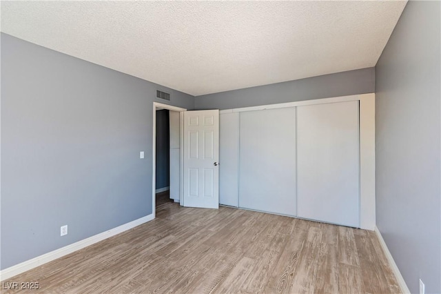 1372 Lorilyn Ave Unit 3, Las Vegas, NV 89119 - unfurnished bedroom featuring wood finished floors, a closet, and a textured ceiling