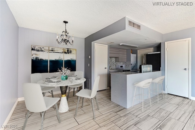 1372 Lorilyn Ave Unit 3, Las Vegas, NV 89119 - dining area featuring a chandelier and a textured ceiling