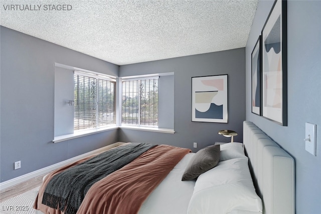 1372 Lorilyn Ave Unit 3, Las Vegas, NV 89119 - bedroom with a textured ceiling and wood finished floors