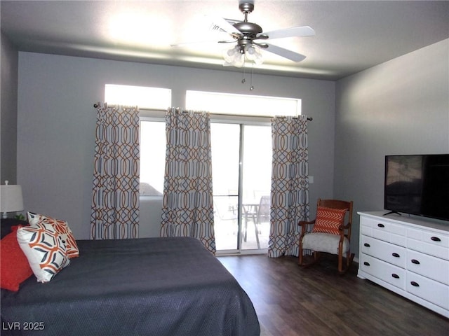 3337 Partridge Run St, Laughlin, NV 89029 - bedroom with access to exterior, dark wood-style floors, and a ceiling fan