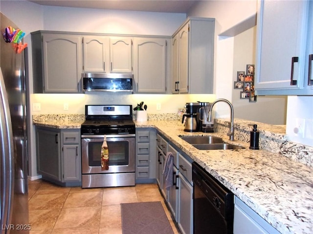 3337 Partridge Run St, Laughlin, NV 89029 - kitchen with stainless steel appliances, gray cabinets, and light stone countertops