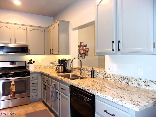 3337 Partridge Run St, Laughlin, NV 89029 - kitchen with appliances with stainless steel finishes, gray cabinets, light stone countertops, and light tile patterned flooring