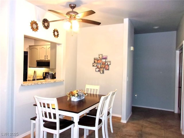 3337 Partridge Run St, Laughlin, NV 89029 - dining space with a ceiling fan and dark tile patterned flooring
