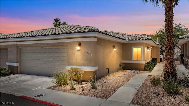 3337 Partridge Run St, Laughlin, NV 89029 - view of front of property featuring a tile roof, concrete driveway, stucco siding, and an attached garage