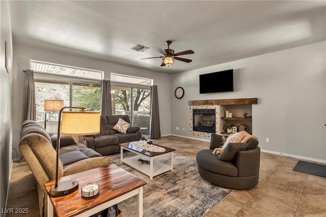 3337 Partridge Run St, Laughlin, NV 89029 - living area with ceiling fan, a tiled fireplace, and light tile patterned flooring