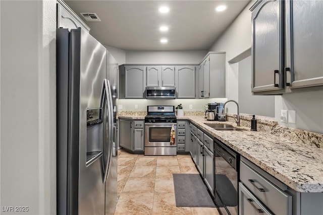 3337 Partridge Run St, Laughlin, NV 89029 - kitchen featuring appliances with stainless steel finishes, gray cabinets, light stone counters, and recessed lighting