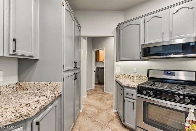 3337 Partridge Run St, Laughlin, NV 89029 - kitchen with appliances with stainless steel finishes, gray cabinets, and light tile patterned flooring