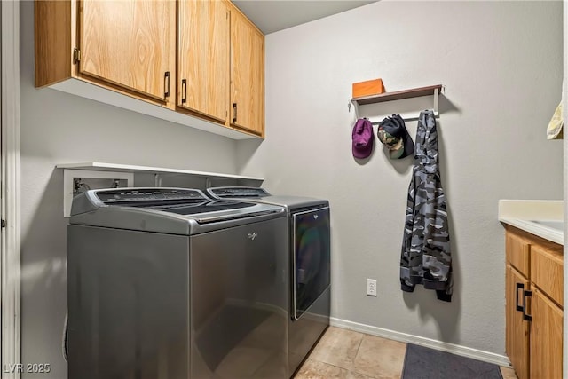 3337 Partridge Run St, Laughlin, NV 89029 - laundry area featuring independent washer and dryer, cabinet space, and light tile patterned floors