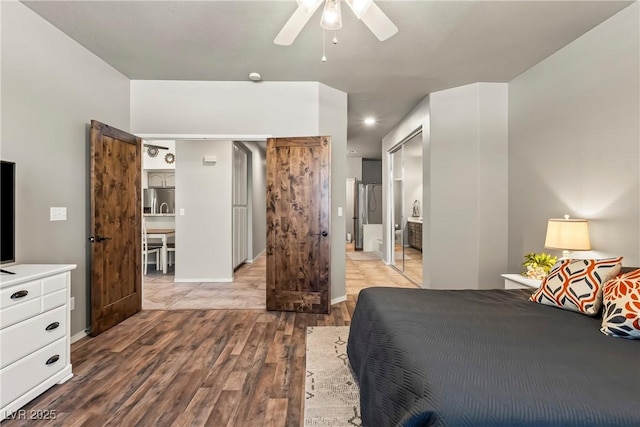 3337 Partridge Run St, Laughlin, NV 89029 - bedroom with wood finished floors, stainless steel fridge, ensuite bathroom, and ceiling fan