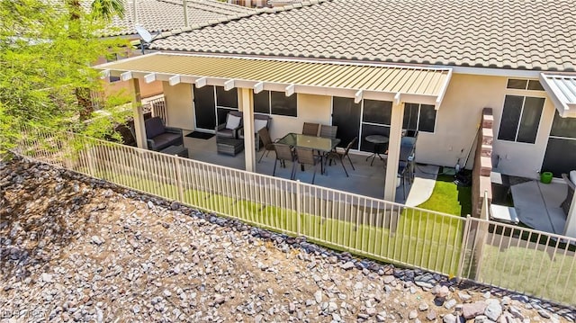 3337 Partridge Run St, Laughlin, NV 89029 - rear view of house with an outdoor living space, a tiled roof, stucco siding, a fenced backyard, and a patio