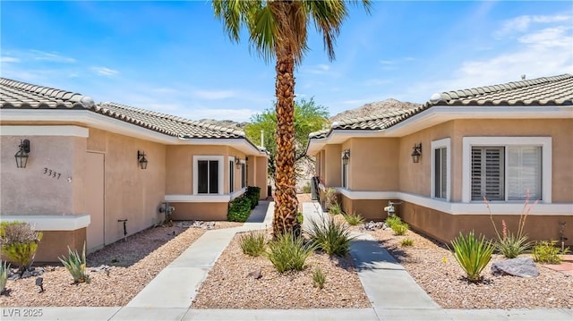 3337 Partridge Run St, Laughlin, NV 89029 - doorway to property with a tiled roof and stucco siding