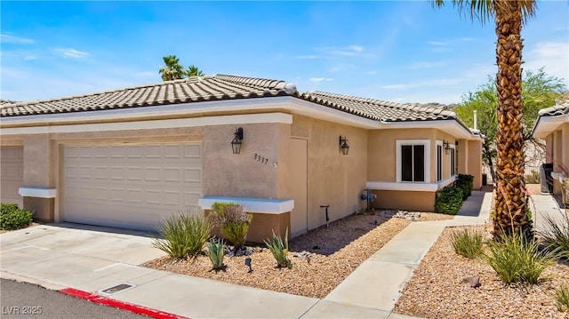 3337 Partridge Run St, Laughlin, NV 89029 - view of front of home featuring a tile roof, stucco siding, concrete driveway, and an attached garage
