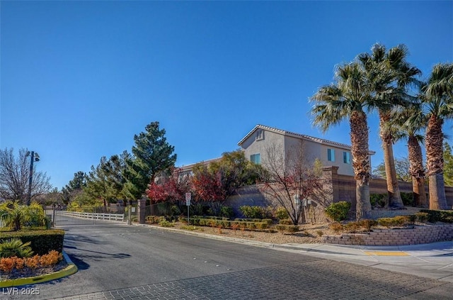 8768 Tom Noon Ave Unit 101, Las Vegas, NV 89178 - view of asphalt road with curbs, a gate, and a gated entry